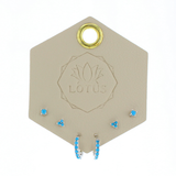 Lotus Studio Silver Trio Earrings in Eva, turquoise flower studs, star studs and turquoise huggies on a Lotus card