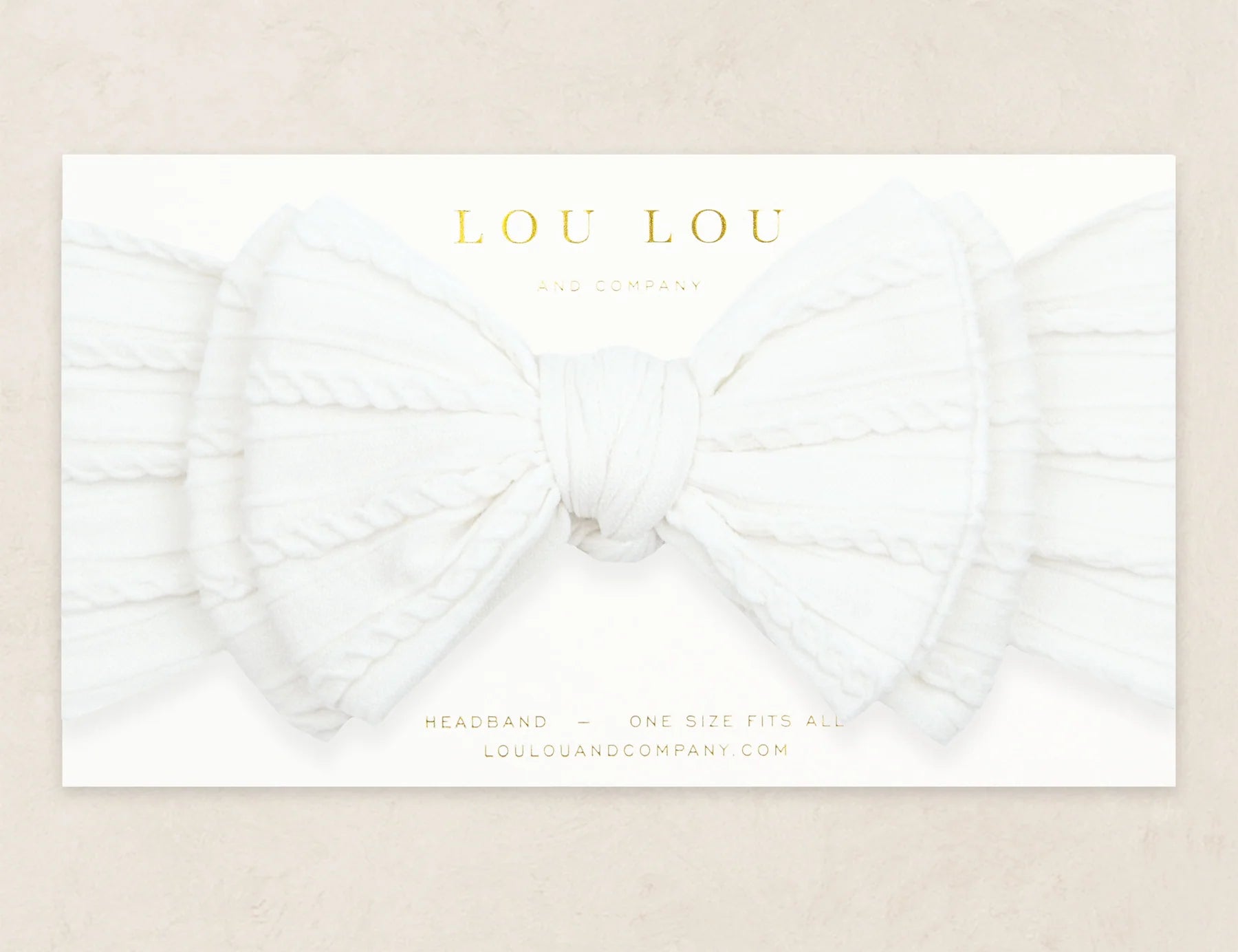 Lou Lou & Company Cable Knit Headband in Crystal White, a soft white bow headband on its card