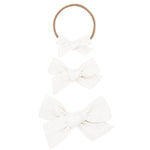 Lou Lou & Company Classic Bow in White, shown as a nylon headband and two clip bows