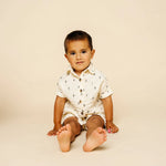 Baby sitting in the Lou Lou & Company Cloud Muslin Shirt and Shorts in Lightning Bolt