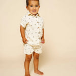 Toddler standing in the Lou Lou & Company Cloud Muslin Shirt and Shorts in Lightning Bolt
