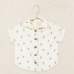 Lou Lou & Company Cloud Muslin Shirt in Lightning Bolt, a cream button-front shirt with a tiny bolt print on a hanger