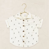 Lou Lou & Company Cloud Muslin Shirt in Lightning Bolt, a cream button-front shirt with a tiny bolt print on a hanger
