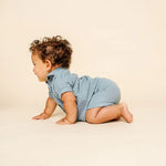 Baby crawling in the Lou Lou & Company Cloud Muslin Shirt and Shorts in Steel