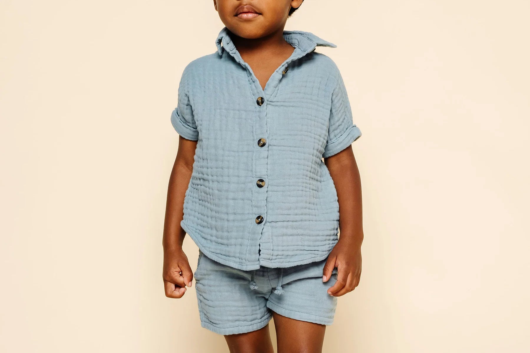 Toddler facing forward wearing the Lou Lou & Company Cloud Muslin Shirt and Shorts in Steel