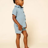 Toddler in profile wearing the Lou Lou & Company Cloud Muslin Shirt and Shorts in Steel