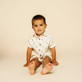 Baby sitting in the Lou Lou & Company Cloud Muslin Shorts and Shirt in Lightning Bolt