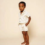 Toddler with hands in pockets wearing the Lou Lou & Company Cloud Muslin Shorts and Shirt in Lightning Bolt