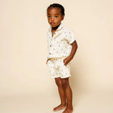 Toddler with hands in pockets wearing the Lou Lou & Company Cloud Muslin Shorts and Shirt in Lightning Bolt