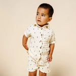 Toddler looking to the side wearing the Lou Lou & Company Cloud Muslin Shorts and Shirt in Lightning Bolt
