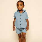 Toddler facing forward wearing the Lou Lou & Company Cloud Muslin Shorts and Shirt in Steel