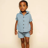 Toddler facing forward wearing the Lou Lou & Company Cloud Muslin Shorts and Shirt in Steel