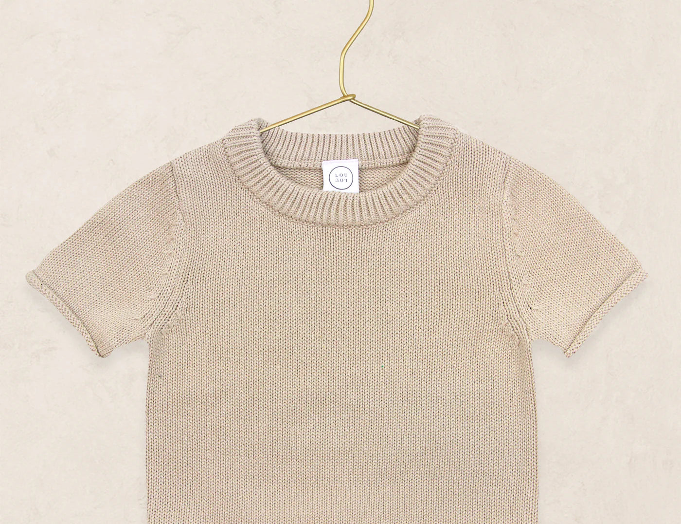 Lou Lou & Company Knit Short Sleeve Tee in Tan, a cotton knit baby tee on a hanger