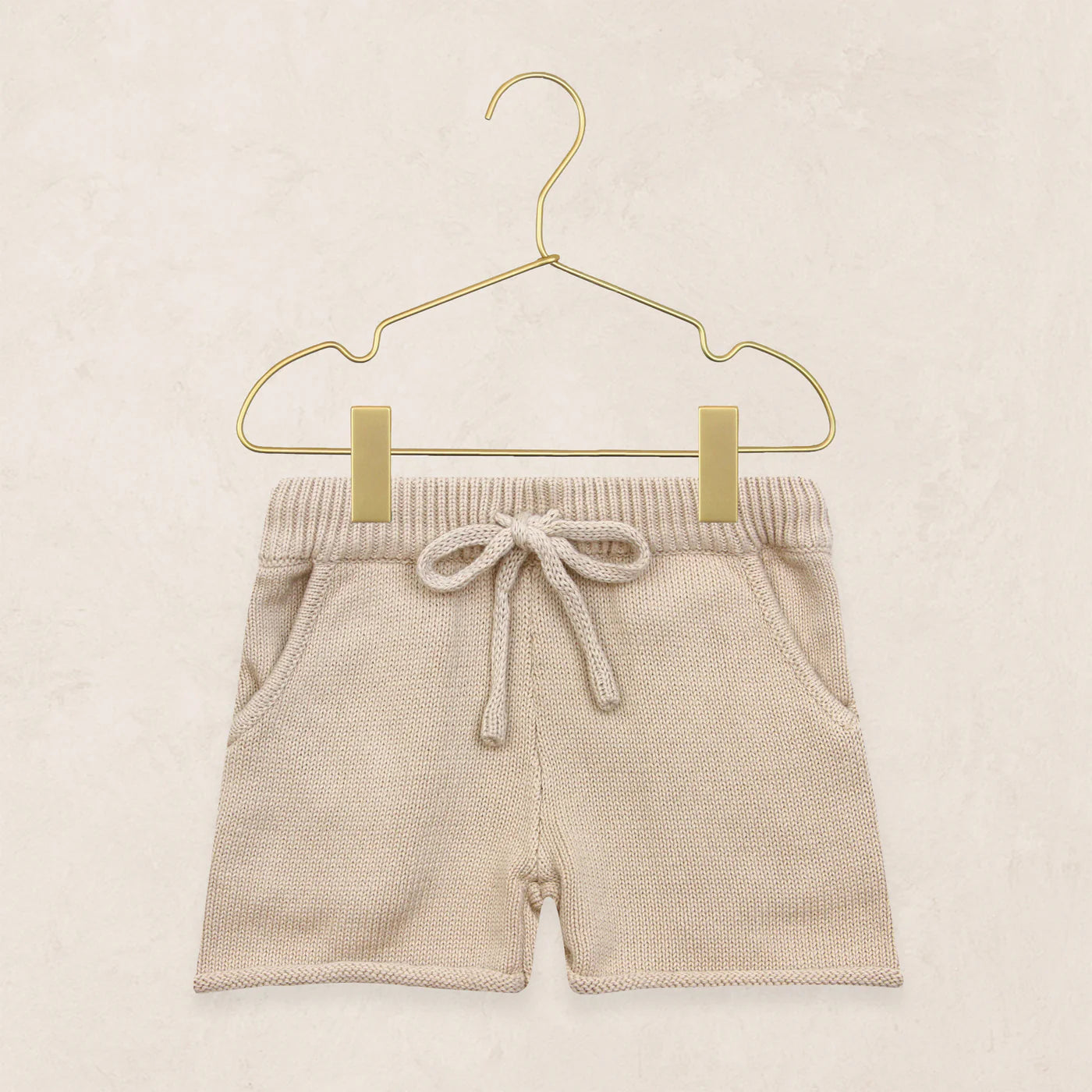 Lou Lou & Company Knit Shorts in Tan, cotton knit drawstring baby shorts on a hanger