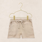 Lou Lou & Company Knit Shorts in Tan, cotton knit drawstring baby shorts on a hanger