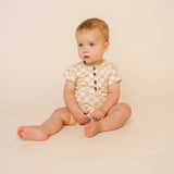 Baby sitting up wearing the Lou Lou & Company Romper in Austin checkered print