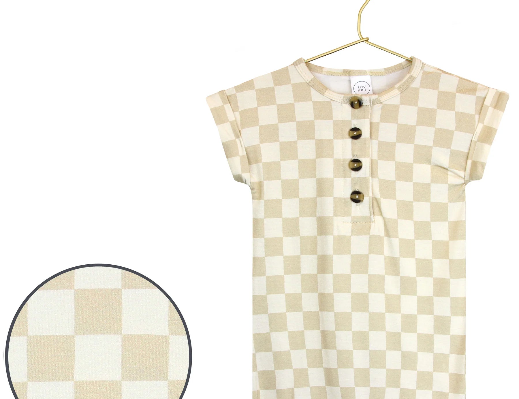 Lou Lou & Company Romper in Austin, a cream and tan checkered short-sleeve henley romper on a hanger