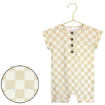 Lou Lou & Company Romper in Austin, a cream and tan checkered short-sleeve henley romper on a hanger