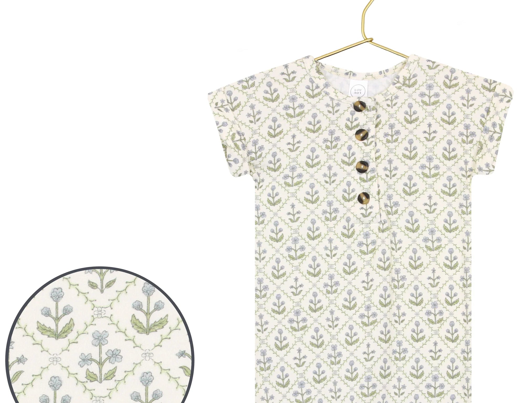 Lou Lou & Company Romper in Etta, a cream henley romper with a green and blue block-print floral, on a hanger