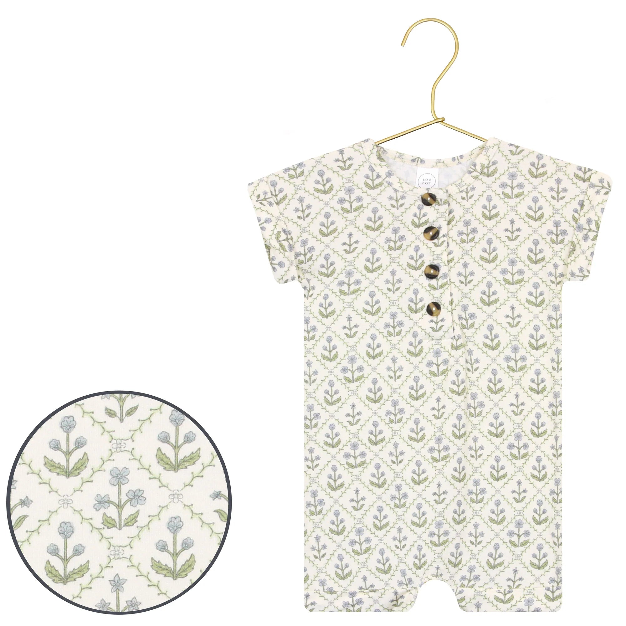 Lou Lou & Company Romper in Etta, a cream henley romper with a green and blue block-print floral, on a hanger