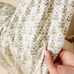 Close-up of the green and blue block-print floral fabric on the Lou Lou & Company Romper in Etta