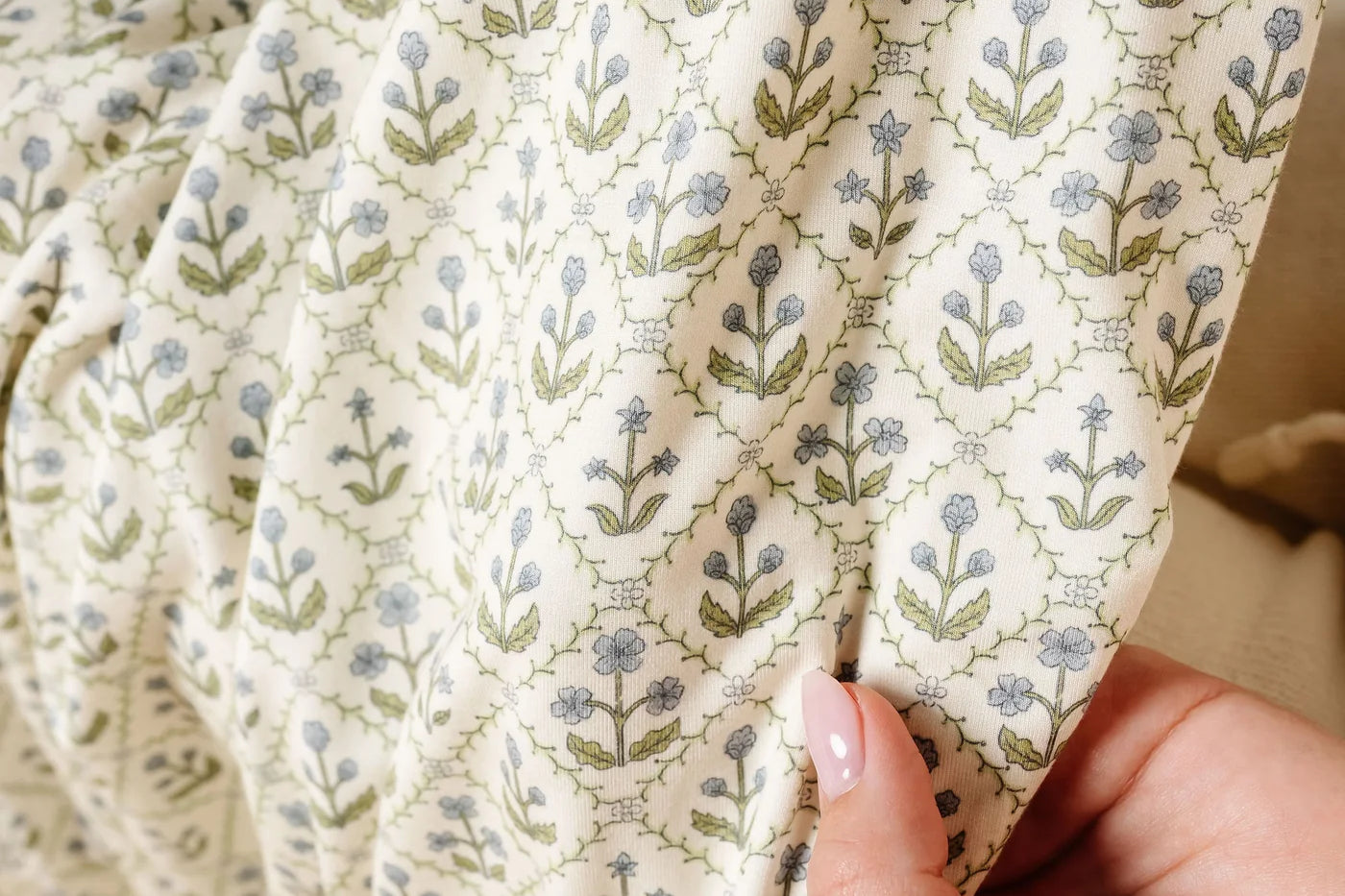 Close-up of the green and blue block-print floral fabric on the Lou Lou & Company Romper in Etta