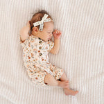 Sleeping newborn wearing the Lou Lou & Company Romper in Rachel floral print