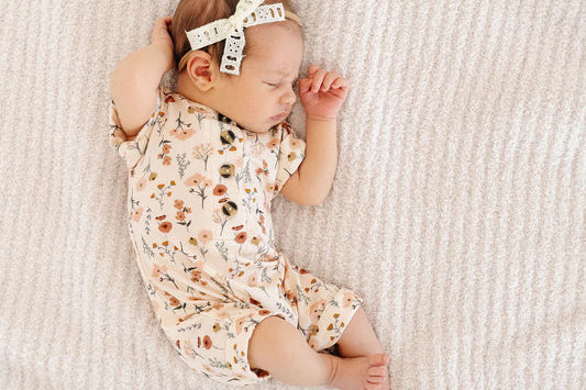 Sleeping newborn wearing the Lou Lou & Company Romper in Rachel floral print