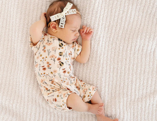 Sleeping newborn wearing the Lou Lou & Company Romper in Rachel floral print