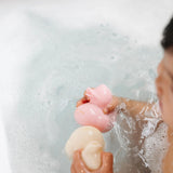 Lou Lou & Company Rubber Duckies in pink and cream floating in a bubble bath