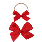 Lou Lou & Company Satin Bow in Cherry, two red satin bows on a soft nylon headband