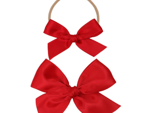 Lou Lou & Company Satin Bow in Cherry, two red satin bows on a soft nylon headband