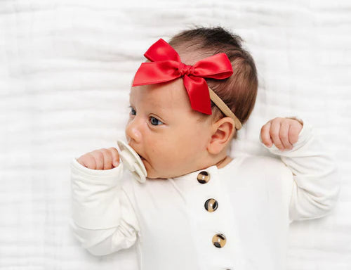 Newborn in a white onesie wearing the Lou Lou & Company Satin Bow in Cherry