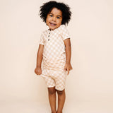 Smiling toddler with curly hair wearing the Lou Lou & Company Shortie Set in Austin checkered print