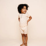 Toddler in profile with hands behind back wearing the Lou Lou & Company Shortie Set in Austin