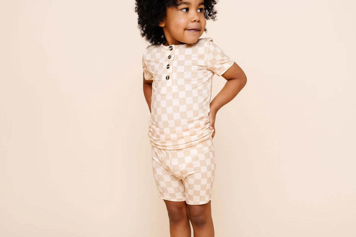 Toddler in profile with hands behind back wearing the Lou Lou & Company Shortie Set in Austin