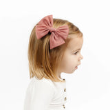 Toddler girl in profile wearing the Lou Lou & Company Tulle Bow Clip in Rose