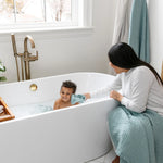 Mother bathing a toddler in a tub with Lou Lou & Company Washcloths in Steel