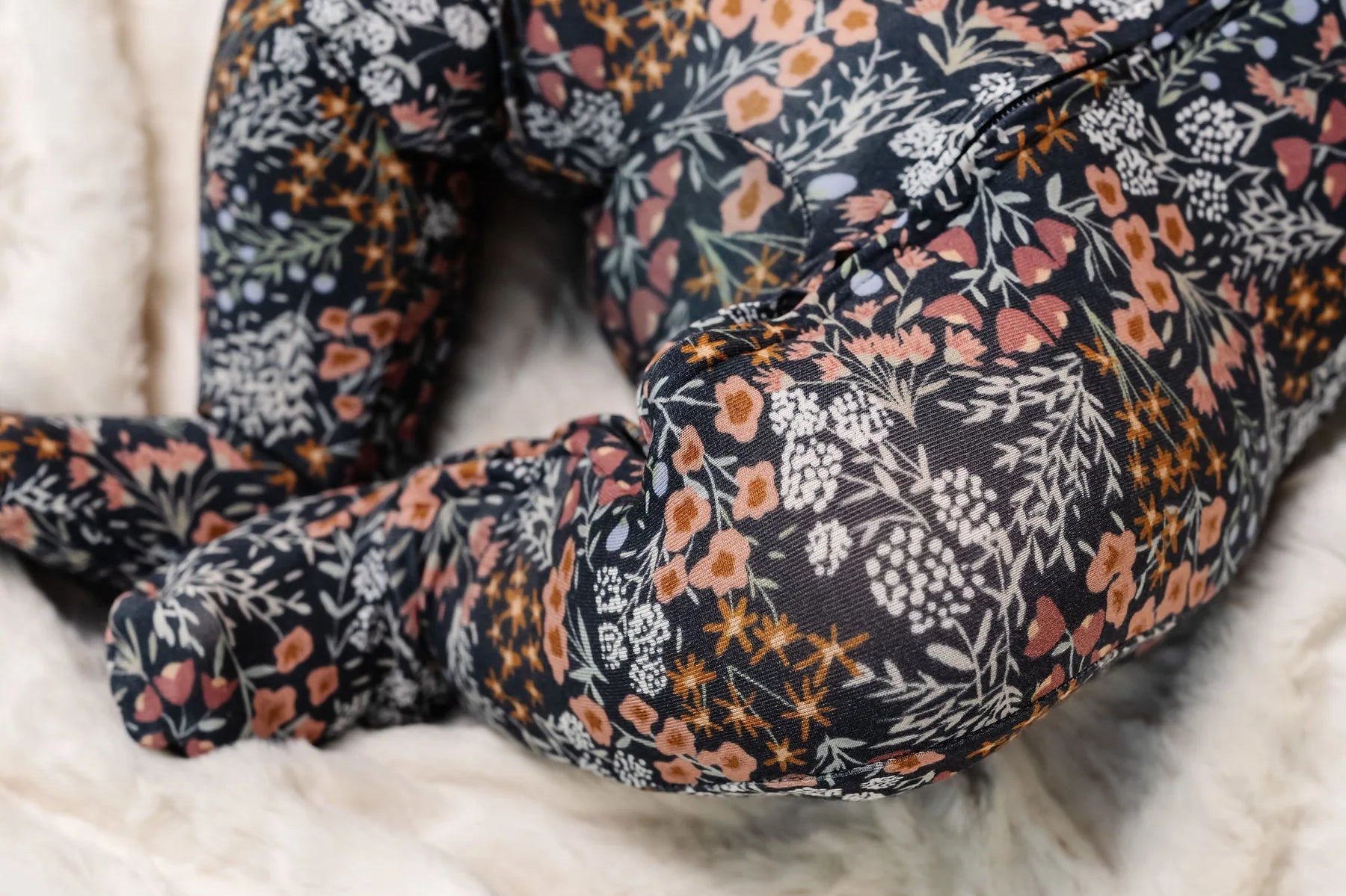 Close-up of the navy floral print and footed legs on the Lou Lou & Company Zipper Footies in Bae