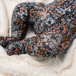 Close-up of the navy floral print and footed legs on the Lou Lou & Company Zipper Footies in Bae
