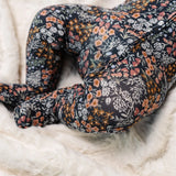 Close-up of the navy floral print and footed legs on the Lou Lou & Company Zipper Footies in Bae
