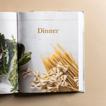 Magnolia Table Cookbook Volume 2 open to the Dinner chapter with pasta and herbs