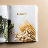 Magnolia Table Cookbook Volume 2 open to the Dinner chapter with pasta and herbs