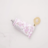 Gold handcreme key rolling up a Lollia Relax handcreme tube