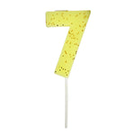 Meri Meri Colored Number Candle 7, a neon yellow birthday candle with gold glitter flecks