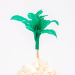 Meri Meri Dinosaur Kingdom Cupcake Kit green palm tree topper on a frosted cupcake
