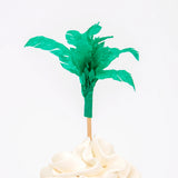 Meri Meri Dinosaur Kingdom Cupcake Kit green palm tree topper on a frosted cupcake
