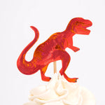 Meri Meri Dinosaur Kingdom Cupcake Kit red T-rex topper on a frosted cupcake