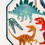 Close-up of the stegosaurus, T-rex and velociraptor illustrations on the Meri Meri Dinosaur Kingdom Dinner Plate