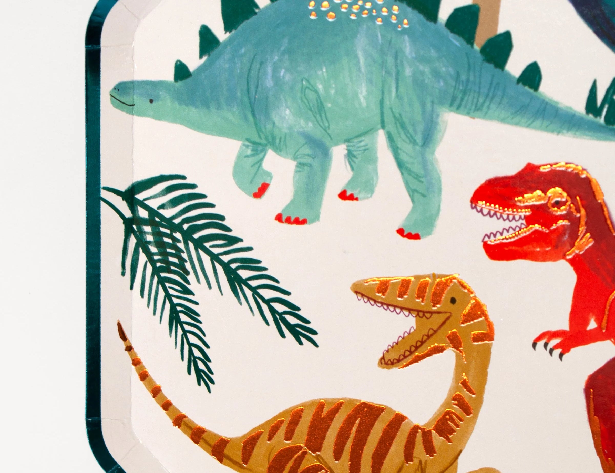 Close-up of the stegosaurus, T-rex and velociraptor illustrations on the Meri Meri Dinosaur Kingdom Dinner Plate